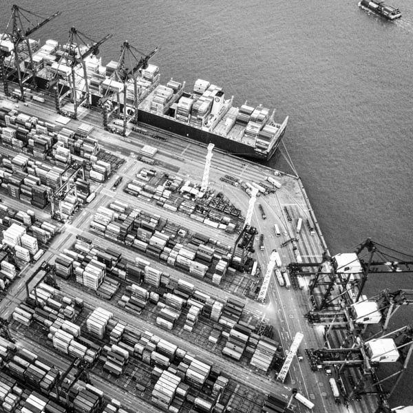 ships being loaded and unloaded in a dock area